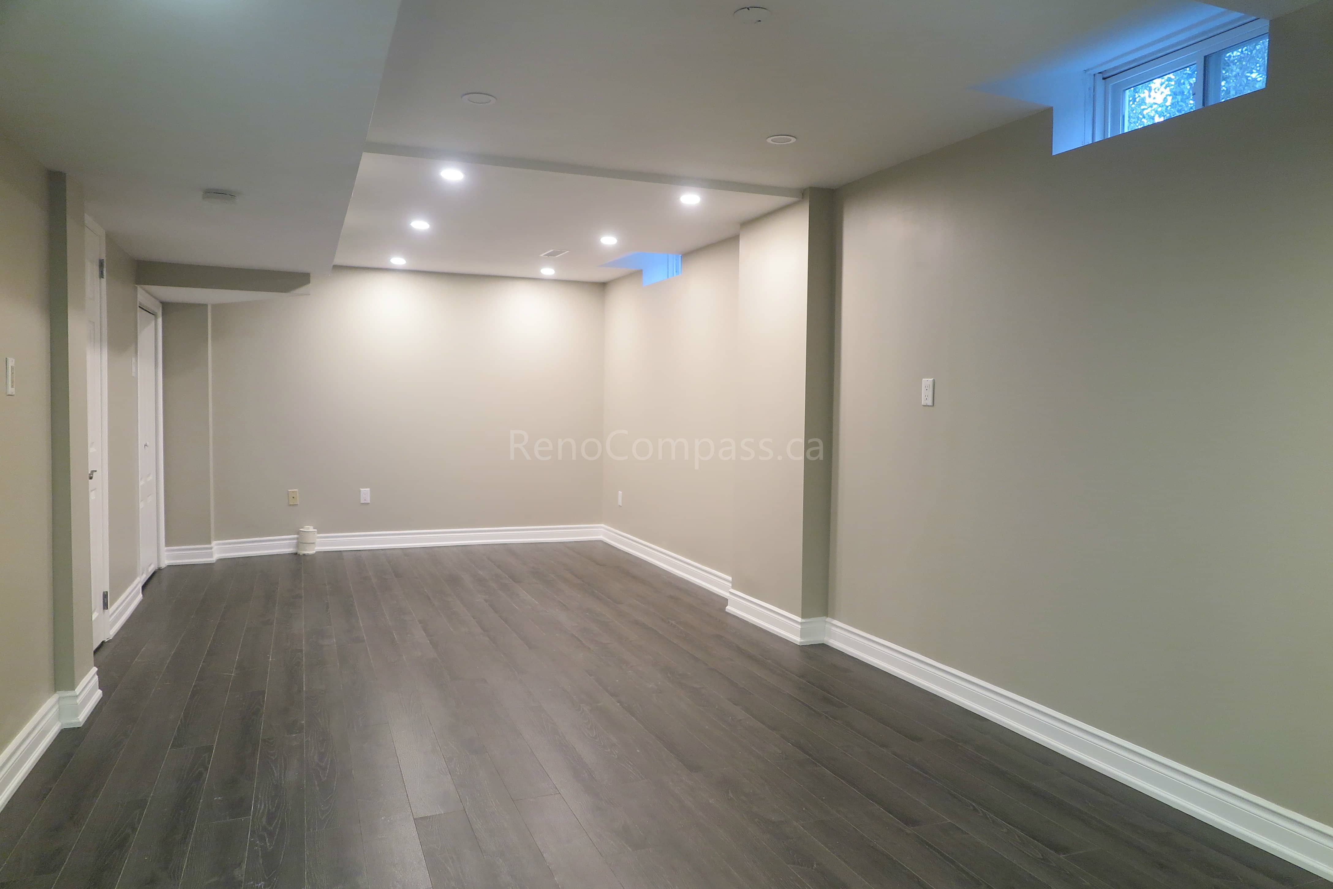 This Markham interior renovation highlights newly installed modern vinyl flooring with a natural wood-grain finish, designed for durability and contemporary style. The flooring enhances the open living space while complementing neutral wall tones, clean baseboard trim, and modern interior finishes. Completed by Reno Compass, a professional renovation contractor specializing in flooring installation and full interior renovations across Markham and the Greater Toronto Area.