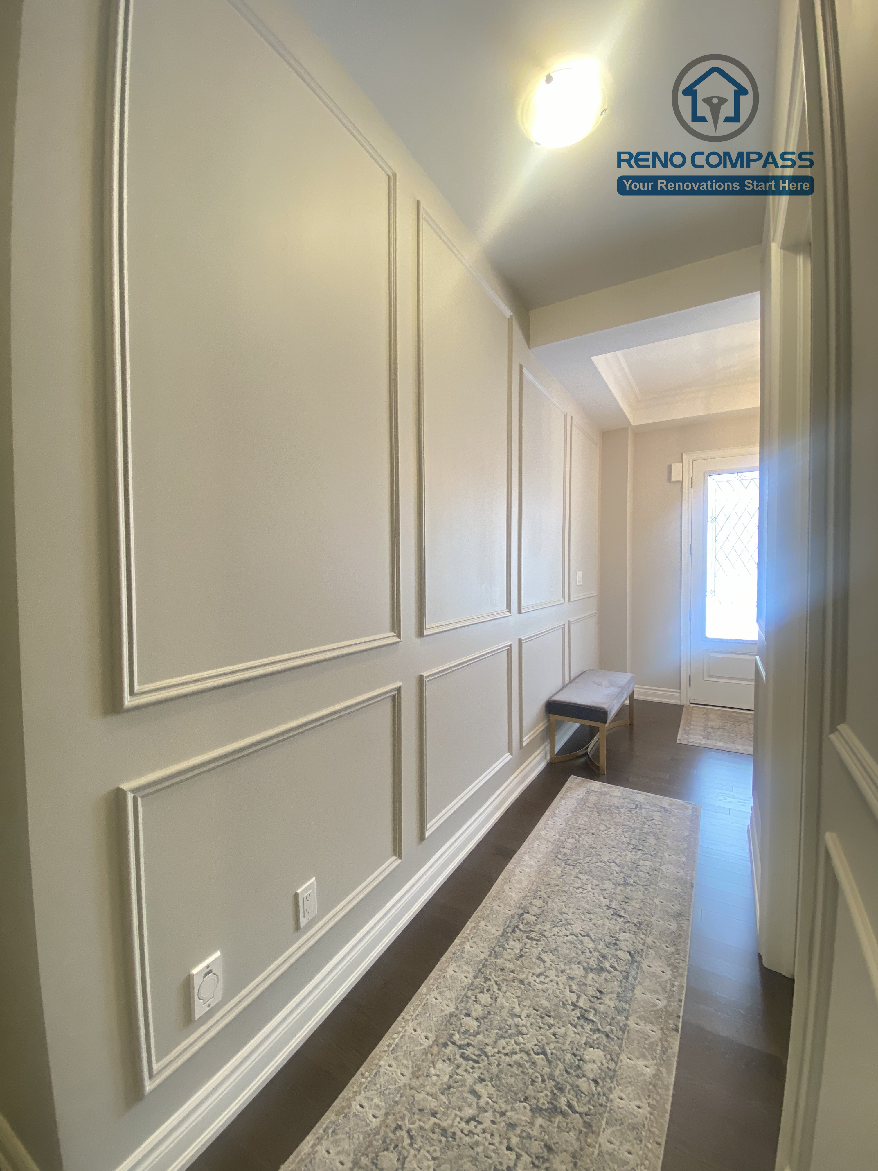 This Vaughan interior renovation features a refined hallway with custom wall paneling, clean trim details, and a long, well-proportioned layout. Subtle lighting and classic millwork enhance the sense of depth and elegance, completed by a professional Toronto renovation company.