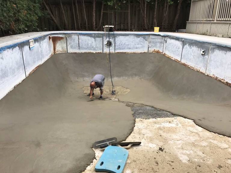 Professional swimming pool restoration in Toronto featuring concrete base repair and resurfacing work. This stage highlights structural repair, leveling, and new concrete application to strengthen the pool foundation and prepare for final finishing, ensuring long-term durability and performance for a residential pool renovation project.