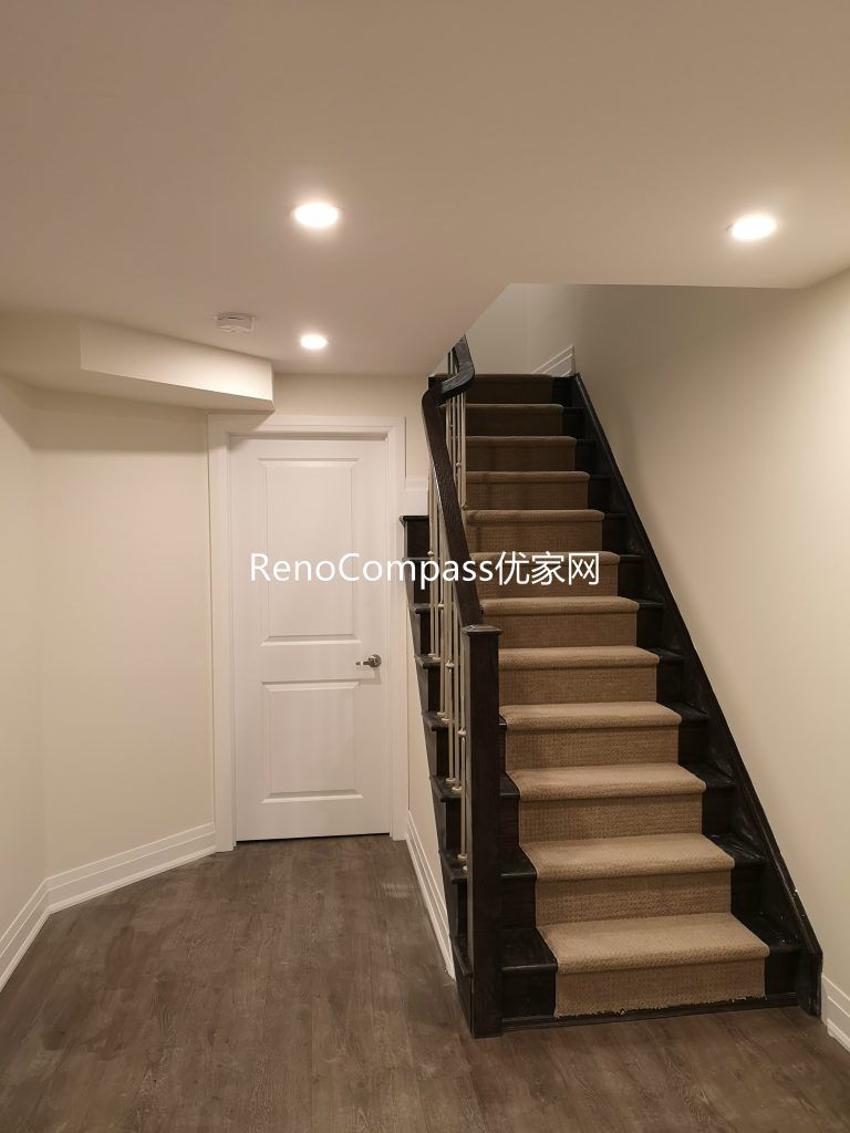 Finished Richmond Hill basement staircase renovation featuring upgraded wood stairs, modern railing, pot lights, and durable flooring. Completed by Reno Compass Inc., this basement upgrade improves safety, brightness, and overall home functionality.