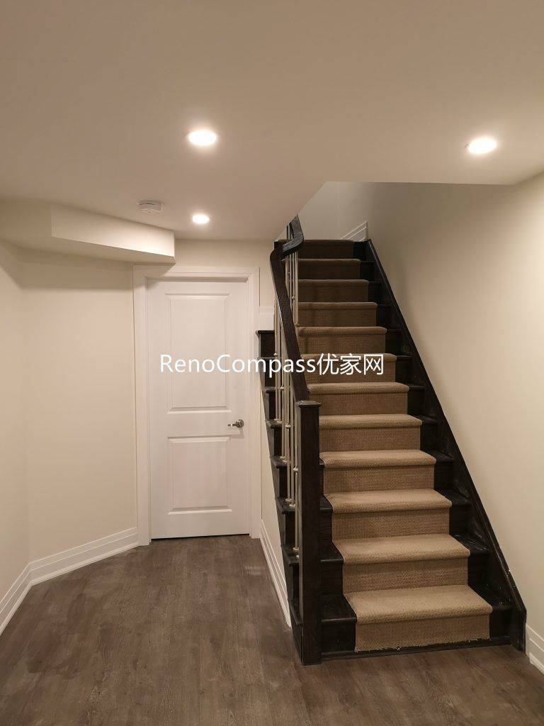 Finished Richmond Hill basement staircase renovation featuring upgraded wood stairs, modern railing, pot lights, and durable flooring. Completed by Reno Compass Inc., this basement upgrade improves safety, brightness, and overall home functionality.