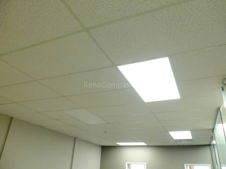 Modern office ceiling renovation in North York featuring suspended acoustic ceiling tiles and energy-efficient LED panel lighting. This commercial office renovation improves lighting quality, workspace comfort, and overall interior aesthetics, completed by a professional Toronto renovation company specializing in office and commercial projects.