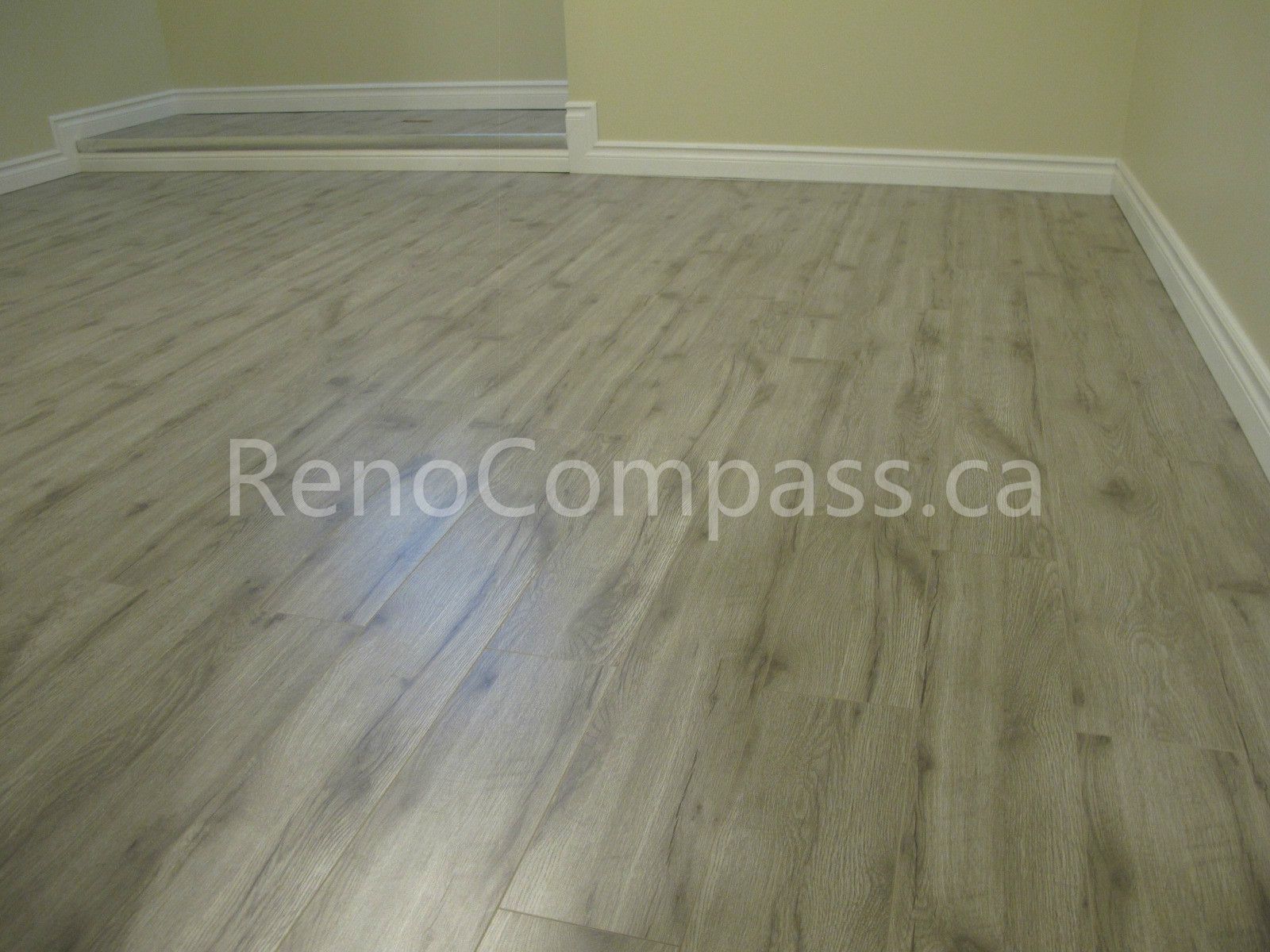 New waterproof vinyl flooring installed in this Markham basement renovation project, featuring durable wood-look planks and clean modern baseboards. Completed by Reno Compass, this basement upgrade enhances comfort, moisture resistance, and contemporary interior style for a functional finished living space.