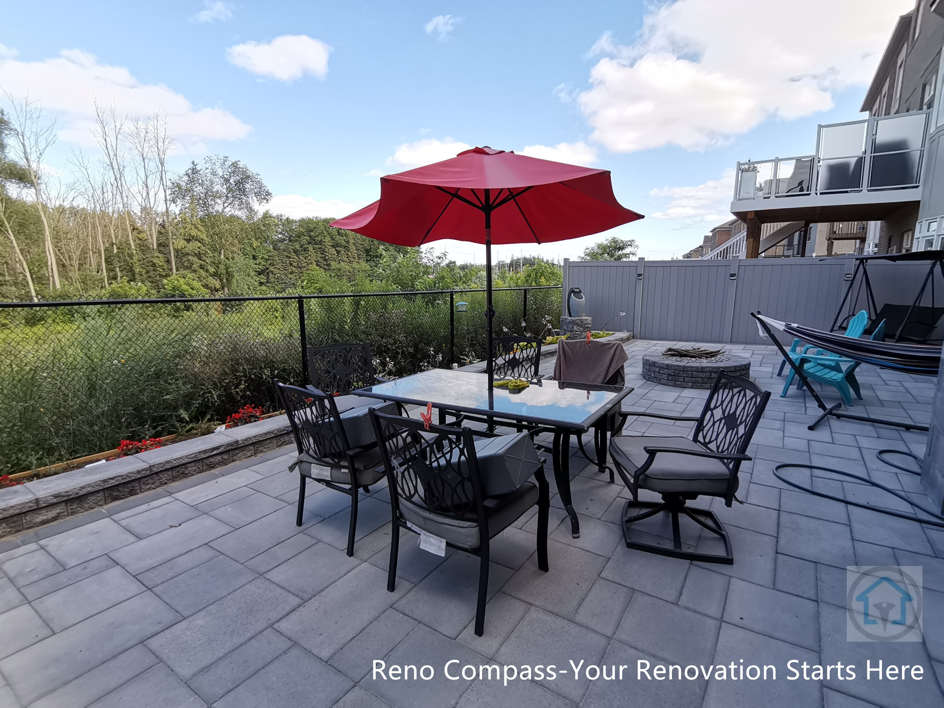 This Vaughan backyard interlocking patio features a spacious stone paver layout designed for outdoor dining and relaxation. The clean paving pattern supports patio furniture and daily use, while the open layout connects seamlessly with the deck structure and fencing, creating a comfortable and functional outdoor living space.