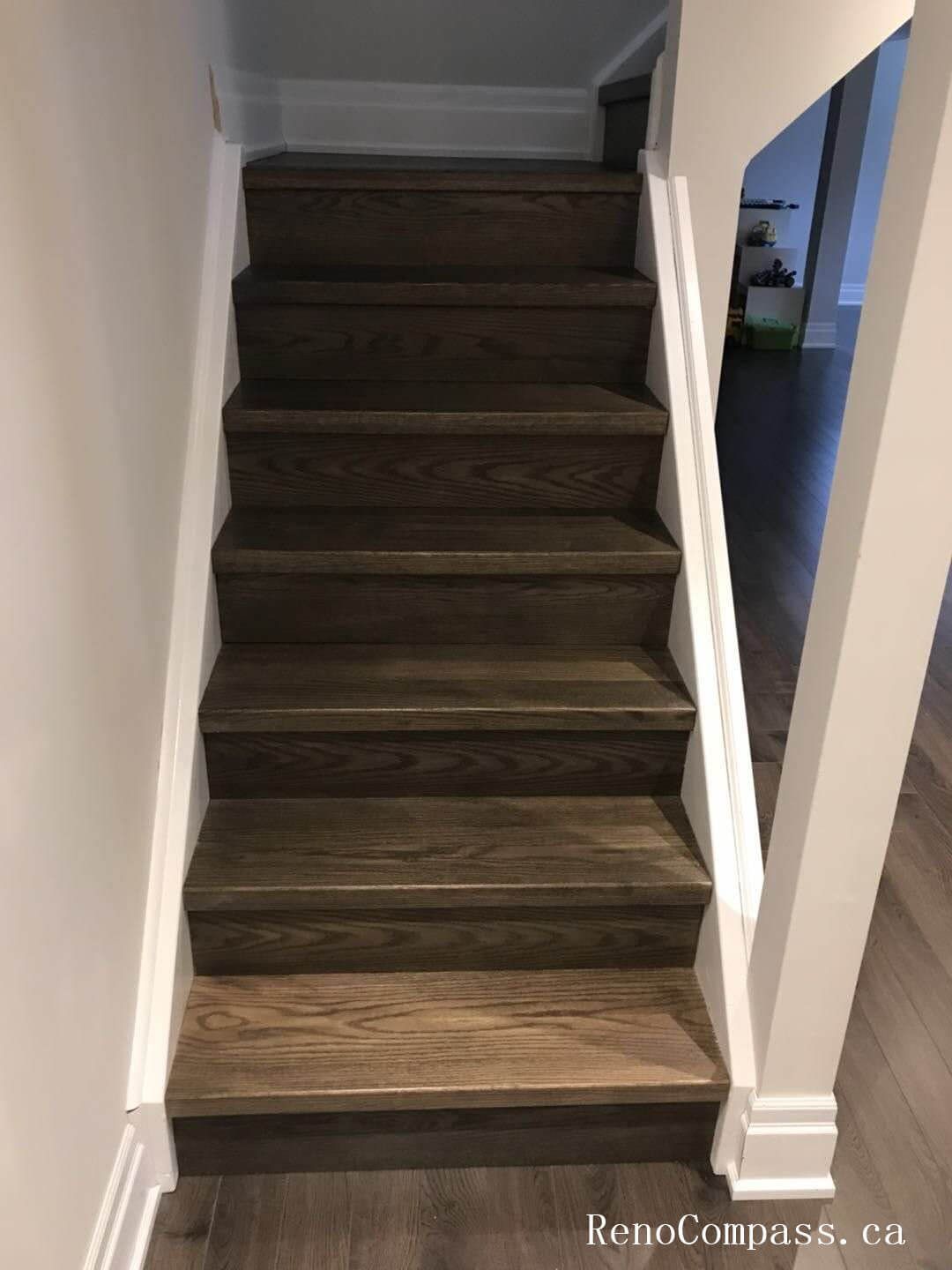 Richmond Hill basement renovation showcasing newly finished staircase with dark wood steps, upgraded baseboards, and clean modern trim work. This basement upgrade enhances safety, durability, and visual continuity, creating a seamless transition between floors with high-quality craftsmanship and contemporary design.
