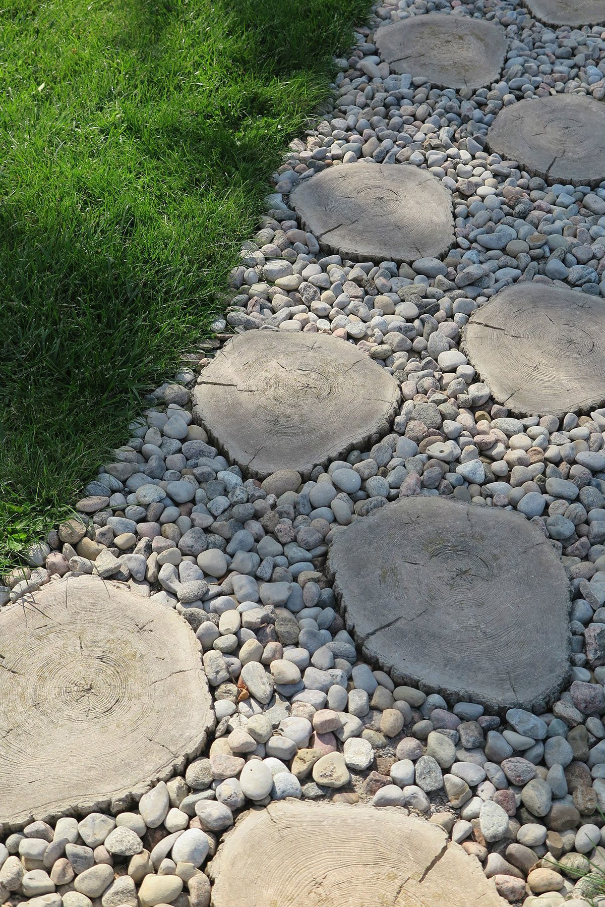 This close-up image highlights the stepping stone pathway detail in a North York landscaping renovation, featuring natural stone pads set in decorative gravel. The design enhances drainage, durability, and safe walking surfaces while blending seamlessly with surrounding lawn areas. Installed by a Toronto Renovation Company specializing in custom landscape pathways and outdoor hardscape detailing.