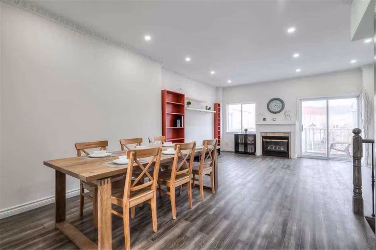 This Thornhill interior renovation features a bright open-concept dining and living area with new wood-style flooring, smooth wall painting, and modern recessed pot lighting. The upgraded staircase with iron railings and refreshed finishes enhance the home’s spacious layout and contemporary style. Completed by a professional Toronto renovation team, this project delivers a clean, functional interior designed for comfortable modern family living.