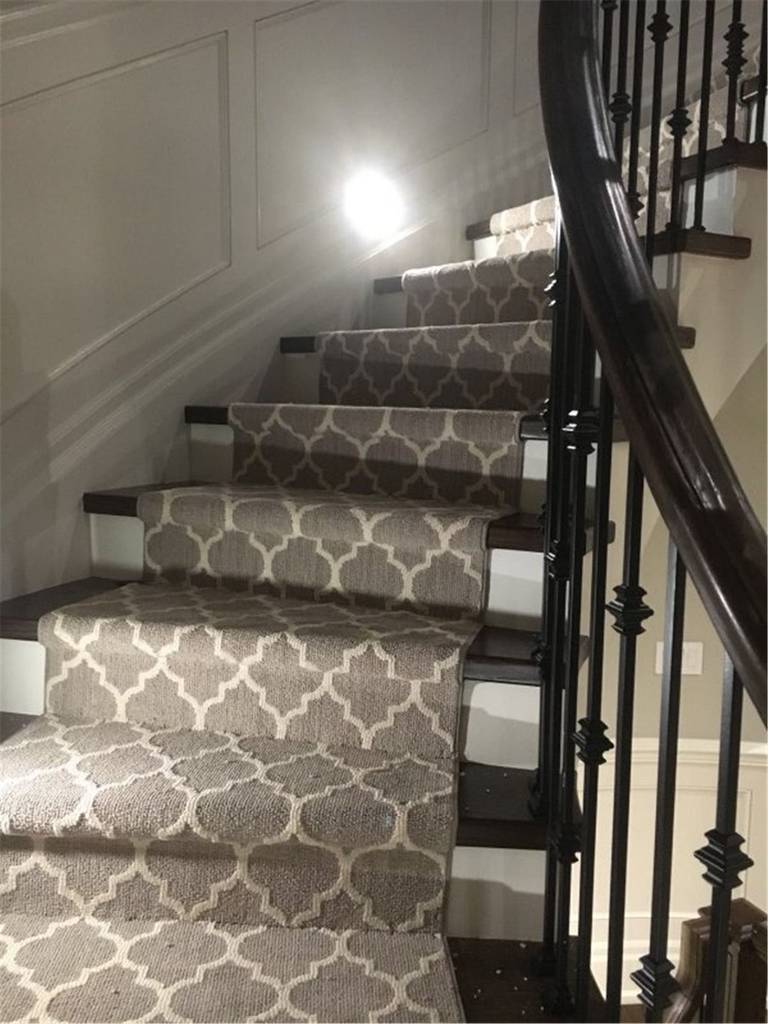 This Toronto interior carpet renovation project showcases a professionally installed staircase carpet runner designed to enhance comfort, safety, and style. The patterned carpet was custom-cut and fitted to align precisely with each stair tread, creating a clean and cohesive look from the upper level to the lower landing.

The neutral-toned runner complements the dark wood stairs and black iron railings, adding warmth while protecting high-traffic areas from wear. Installed by an experienced Toronto renovation company, this staircase carpet upgrade improves daily functionality, reduces noise, and brings a polished, modern finish to the home’s interior stairway.