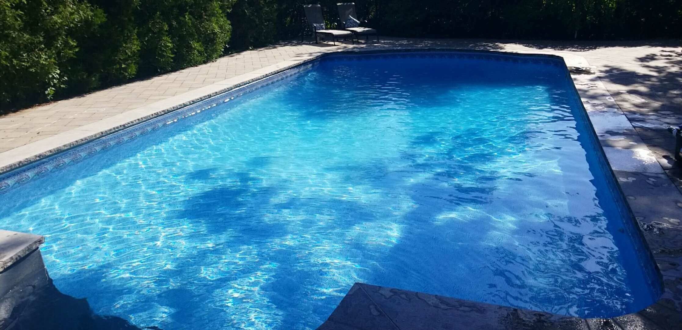 After renovation photo of a fully restored backyard swimming pool in Toronto. The new bright blue liner, clean water, and resurfaced edges highlight the professional pool transformation from old and damaged to modern and inviting. Expert pool renovation by local Toronto specialists.