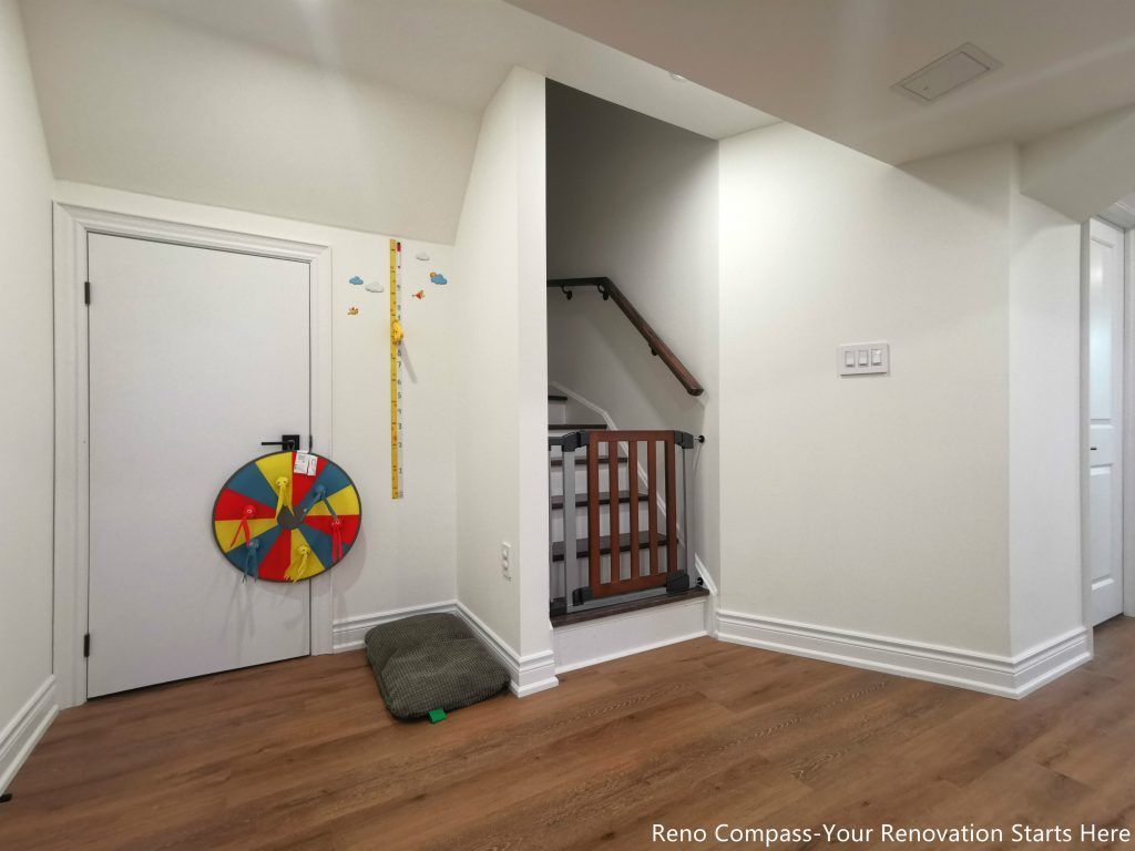 This image showcases a renovated basement staircase and adjacent storage area in Vaughan, highlighting improved circulation and practical space planning. Clean wall finishes, upgraded wood flooring, and safe stair railing installation create a well-organized transition between levels. The enclosed storage door provides functional utility without disrupting the overall layout, making the basement suitable for family use and everyday living. This thoughtful basement renovation emphasizes safety, durability, and efficient use of space, reflecting the quality workmanship of a professional Toronto renovation company.