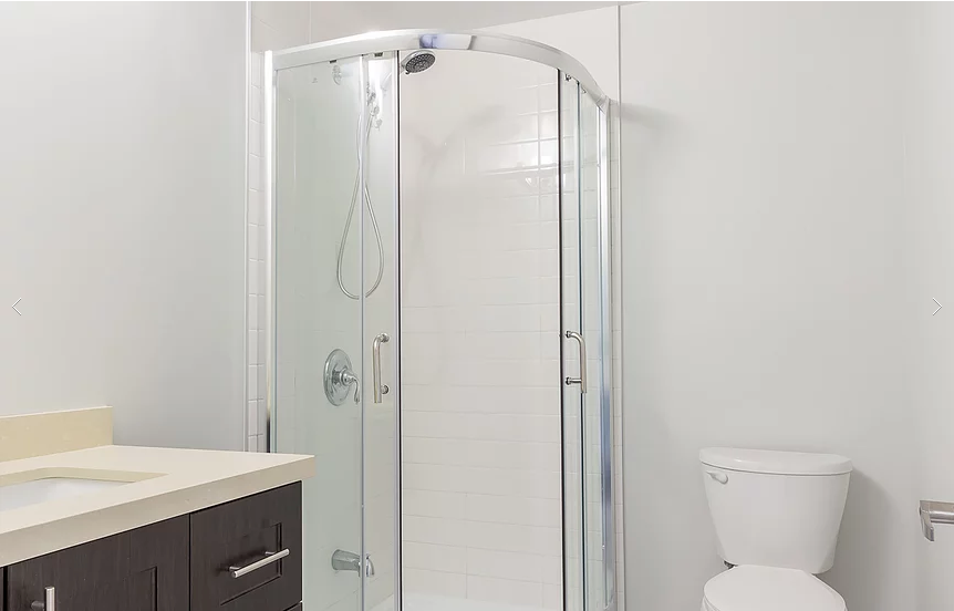 A sleek, contemporary bathroom from our Vaughan full house renovation featuring a frameless glass shower, modern vanity with clean lines, and neutral color palette. Designed for both comfort and elegance, this bathroom showcases efficient use of space and high-quality finishes.