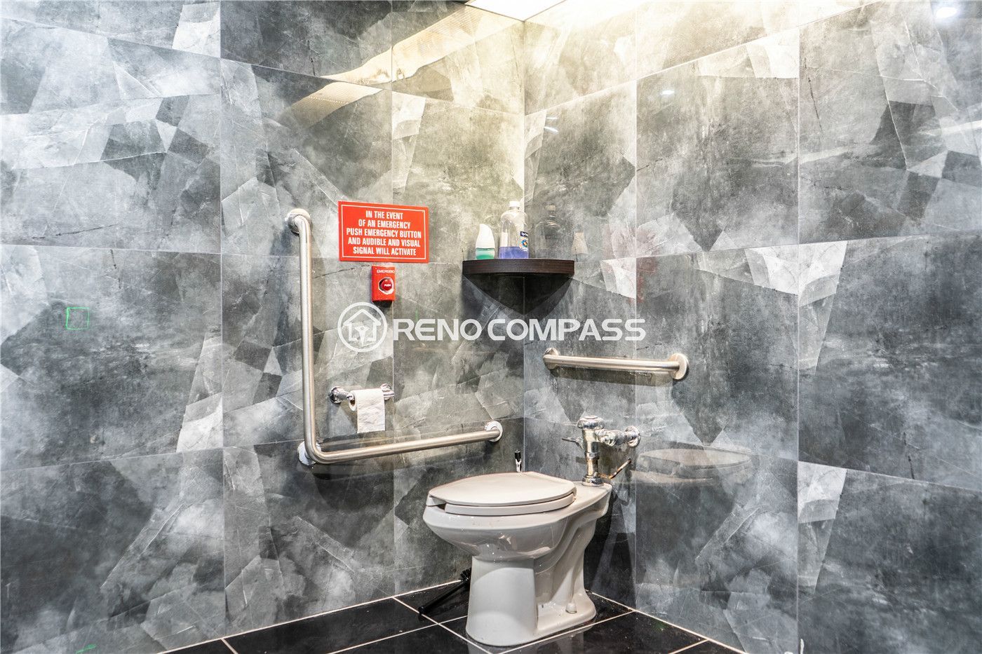 Commercial washroom renovation for a Markham internet cafe featuring modern tile wall finishes, accessibility grab bars, durable flooring, and efficient layout design. This commercial renovation project highlights professional plumbing installation, safety compliance upgrades, and contemporary interior finishing, creating a clean and functional restroom space by experienced Toronto renovation contractor Reno Compass Inc.