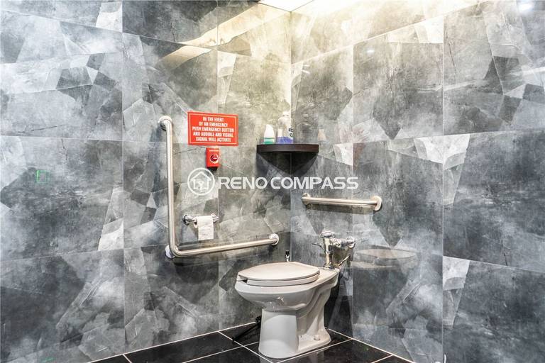 Commercial washroom renovation for a Markham internet cafe featuring modern tile wall finishes, accessibility grab bars, durable flooring, and efficient layout design. This commercial renovation project highlights professional plumbing installation, safety compliance upgrades, and contemporary interior finishing, creating a clean and functional restroom space by experienced Toronto renovation contractor Reno Compass Inc.