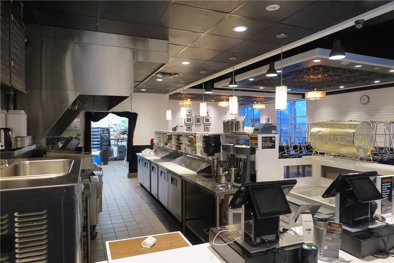 This Toronto restaurant renovation project showcases a fully upgraded commercial kitchen and front service counter area completed by Reno Compass Inc. The scope of work included stainless steel prep stations, commercial-grade ventilation hood installation, new ceiling lighting, POS counter setup, and optimized kitchen workflow layout.

The redesigned space improves operational efficiency, hygiene standards, and customer service flow. Durable flooring, modern pendant lighting, and professional-grade equipment installation ensure the restaurant meets commercial safety codes while maintaining a clean and contemporary appearance.

As a trusted Toronto renovation company, Reno Compass Inc. delivers practical and code-compliant restaurant renovation solutions tailored for food service businesses across the GTA.