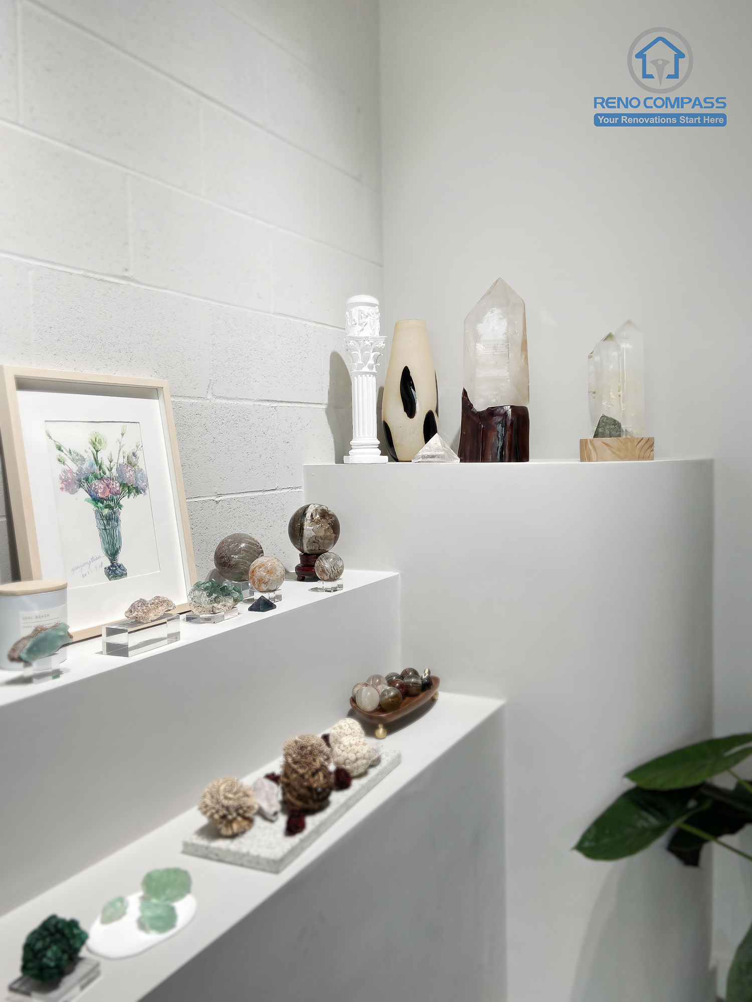 This image highlights a custom-built crystal display corner in a renovated crystal shop located in Markham. The design features clean white display niches, minimalist shelving, and focused lighting to enhance the visual impact of crystals and spiritual items. Neutral wall finishes and polished flooring create a calm, gallery-like retail atmosphere. As a Toronto renovation company, Reno Compass specializes in boutique retail renovations that balance aesthetics, functionality, and customer flow.