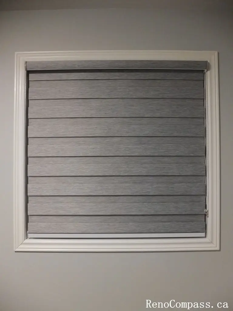 This Richmond Hill curtains installation project features modern custom grey window blinds that enhance privacy, light control, and interior aesthetics. The clean, neutral-toned fabric complements the minimalist wall color and white window trim, creating a balanced and contemporary look. Professionally measured and installed, these custom window coverings improve both functionality and visual appeal, making them a perfect choice for homeowners seeking stylish and practical window treatment solutions in Richmond Hill and the Greater Toronto Area.