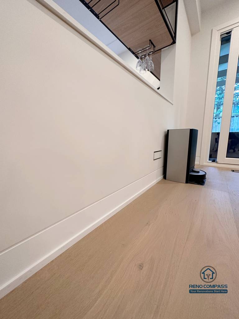 This Toronto flooring renovation detail highlights precision hardwood floor installation with clean baseboard finishing and seamless wall transitions. The light oak flooring enhances brightness and continuity throughout the interior, showcasing high-quality craftsmanship ideal for modern Toronto home renovations.