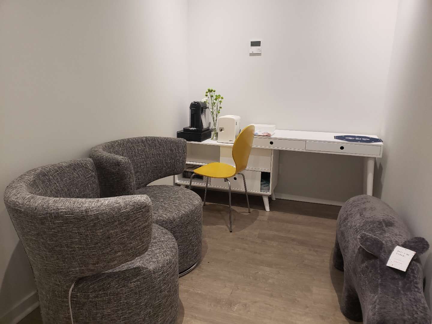 This image features a private consultation and waiting area within a modern beauty and massage spa, completed by a trusted Toronto renovation company specializing in commercial interior renovations. The space is designed with comfortable seating, warm wood flooring, and a clean workstation layout to create a calm and welcoming environment for client consultations and relaxation. Neutral wall tones and soft lighting enhance the tranquil spa atmosphere while maintaining functionality for daily operations. This type of layout is ideal for beauty clinics, wellness studios, and massage therapy centers across Toronto and the GTA seeking a professional and relaxing interior upgrade.