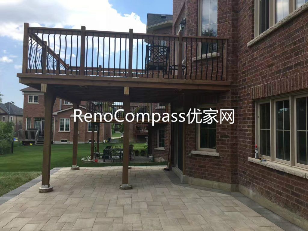 Custom backyard renovation in Richmond Hill featuring elevated wood deck construction with modern railing and professionally installed interlocking stone patio underneath. This outdoor upgrade improves functionality, durability, and visual appeal, creating a versatile multi-level outdoor living and entertaining space.