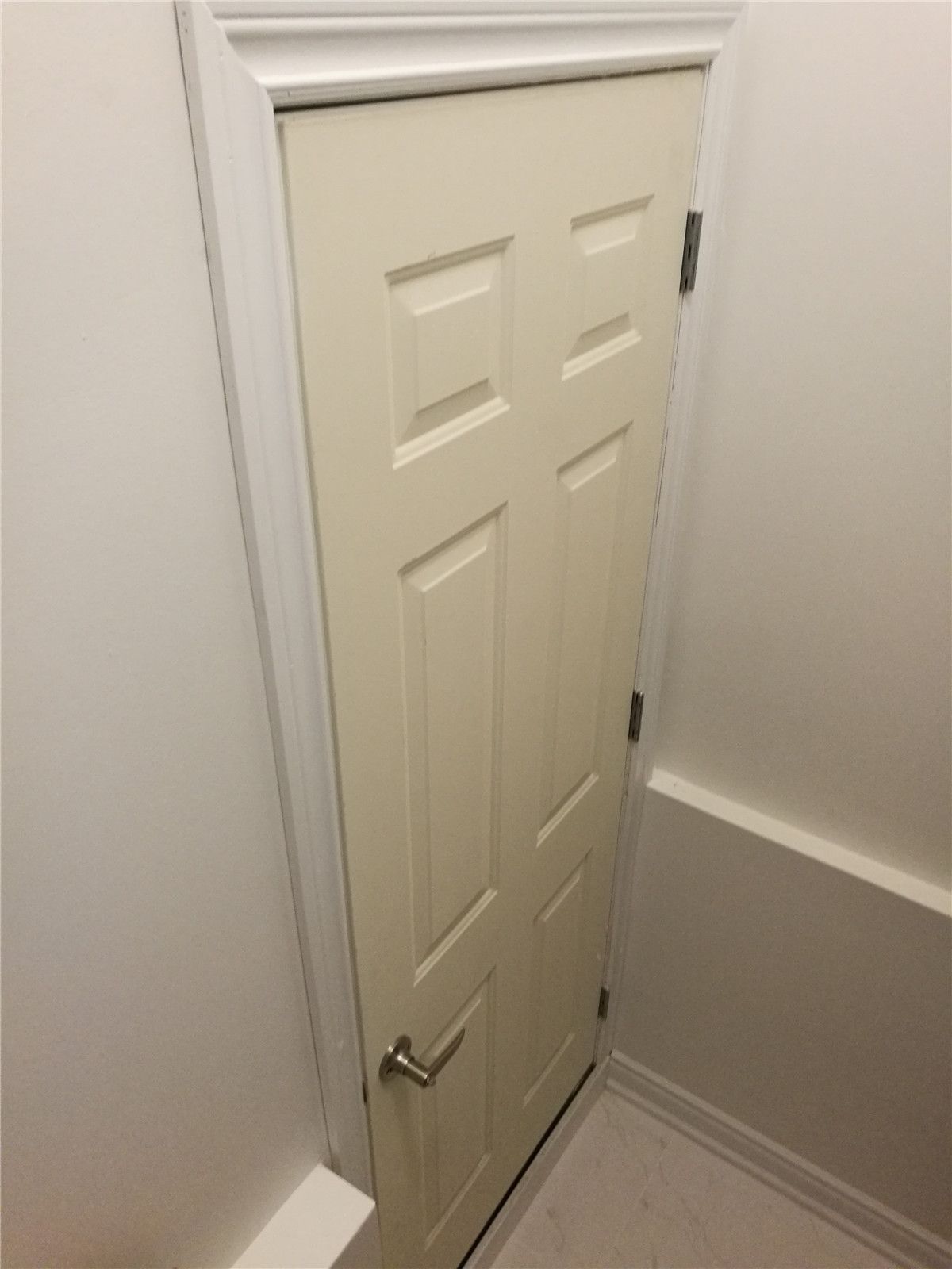 This image showcases a custom interior door installation completed as part of a Vaughan basement renovation project. The compact door design is ideal for under-stair storage or mechanical room access, maximizing space efficiency while maintaining a clean and seamless appearance. Installed by a professional Toronto Renovation Company, the door features precise framing, modern hardware, and smooth finishing that blends naturally with the surrounding walls and trim. The detail-oriented craftsmanship ensures both functionality and long-term durability within the finished basement space.