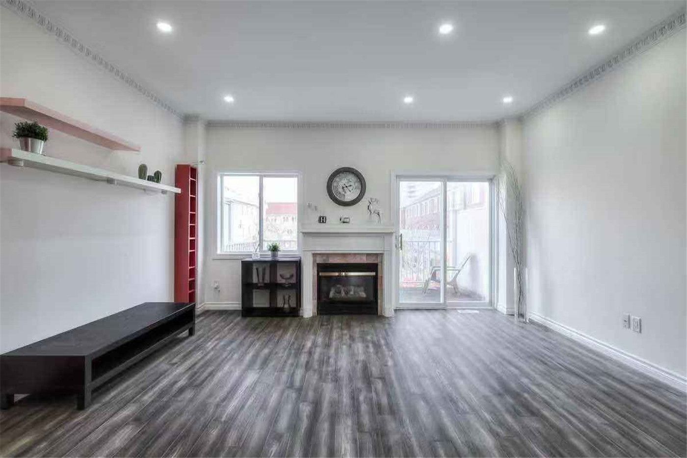 This Thornhill interior renovation showcases a spacious living room upgrade featuring new vinyl flooring, fresh wall painting, modern pot lights, and a refreshed fireplace feature wall. Large windows and sliding patio doors enhance natural light and openness, creating a bright and welcoming environment. Completed by a professional Toronto renovation team, this renovation highlights quality craftsmanship and modern interior design for comfortable family living.