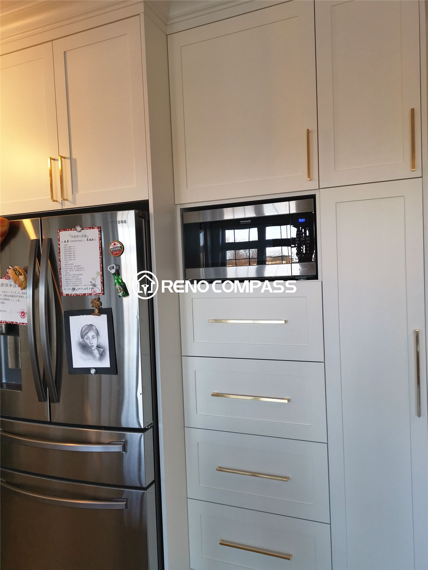 This King City kitchen renovation highlights custom full-height cabinetry with integrated storage solutions and a built-in microwave wall unit for a clean, modern look. Designed with elegant gold hardware and soft neutral cabinetry tones, the space maximizes vertical storage while maintaining a refined and seamless appearance. High-end stainless steel appliances are paired with custom millwork to create a functional and stylish kitchen layout tailored for everyday convenience. Completed by Reno Compass Inc., this project showcases thoughtful space planning and premium craftsmanship in a contemporary kitchen renovation.