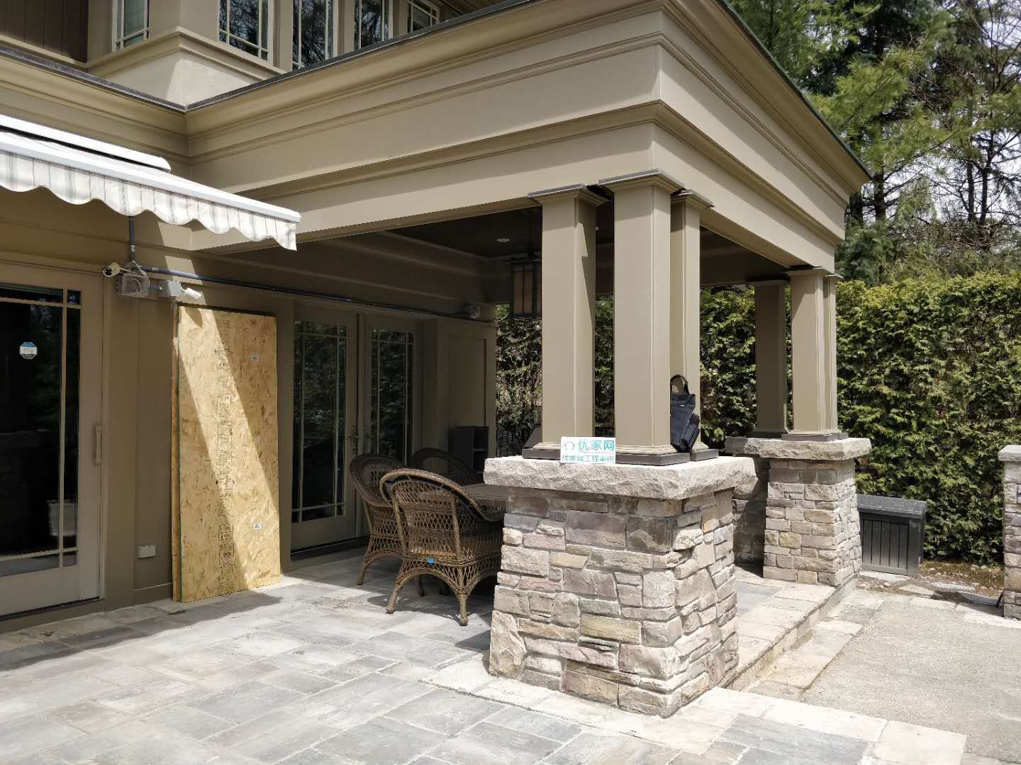 Oakville backyard covered patio featuring stone columns, architectural pillars, and a spacious seating area. Designed for comfort, shade, and elegant outdoor living.