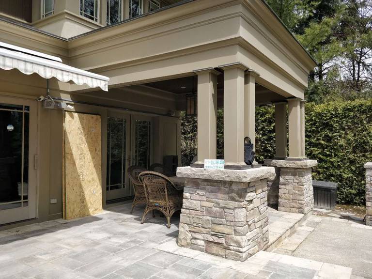 Oakville backyard covered patio featuring stone columns, architectural pillars, and a spacious seating area. Designed for comfort, shade, and elegant outdoor living.