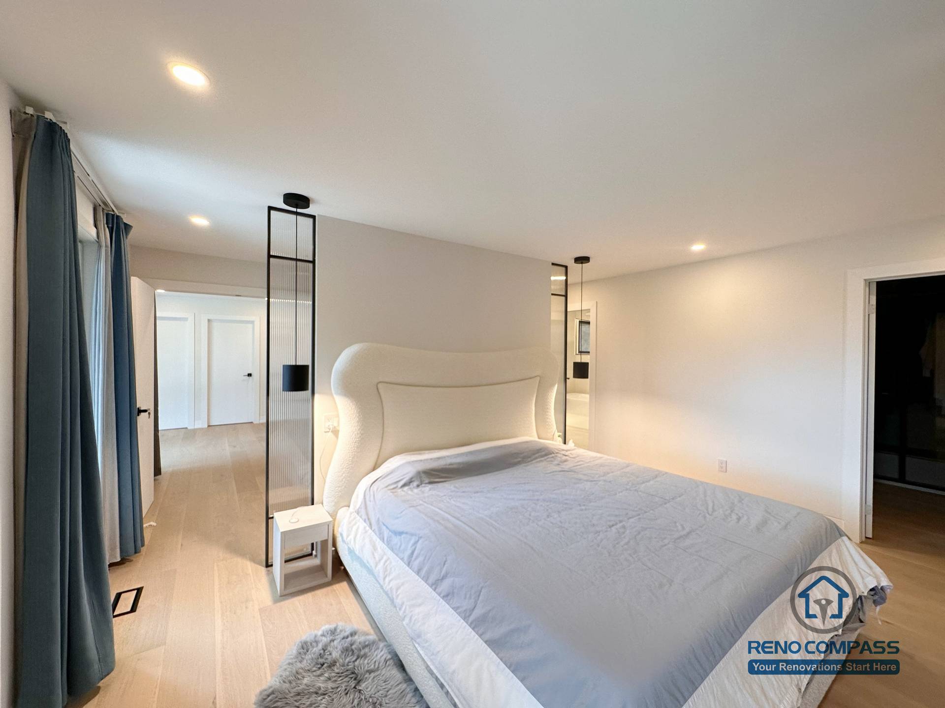 This Toronto bedroom renovation features light hardwood flooring, a modern minimalist layout, and integrated lighting that creates a calm and spacious atmosphere. The seamless flooring installation enhances continuity throughout the interior, showcasing refined craftsmanship ideal for contemporary Toronto home renovations.
