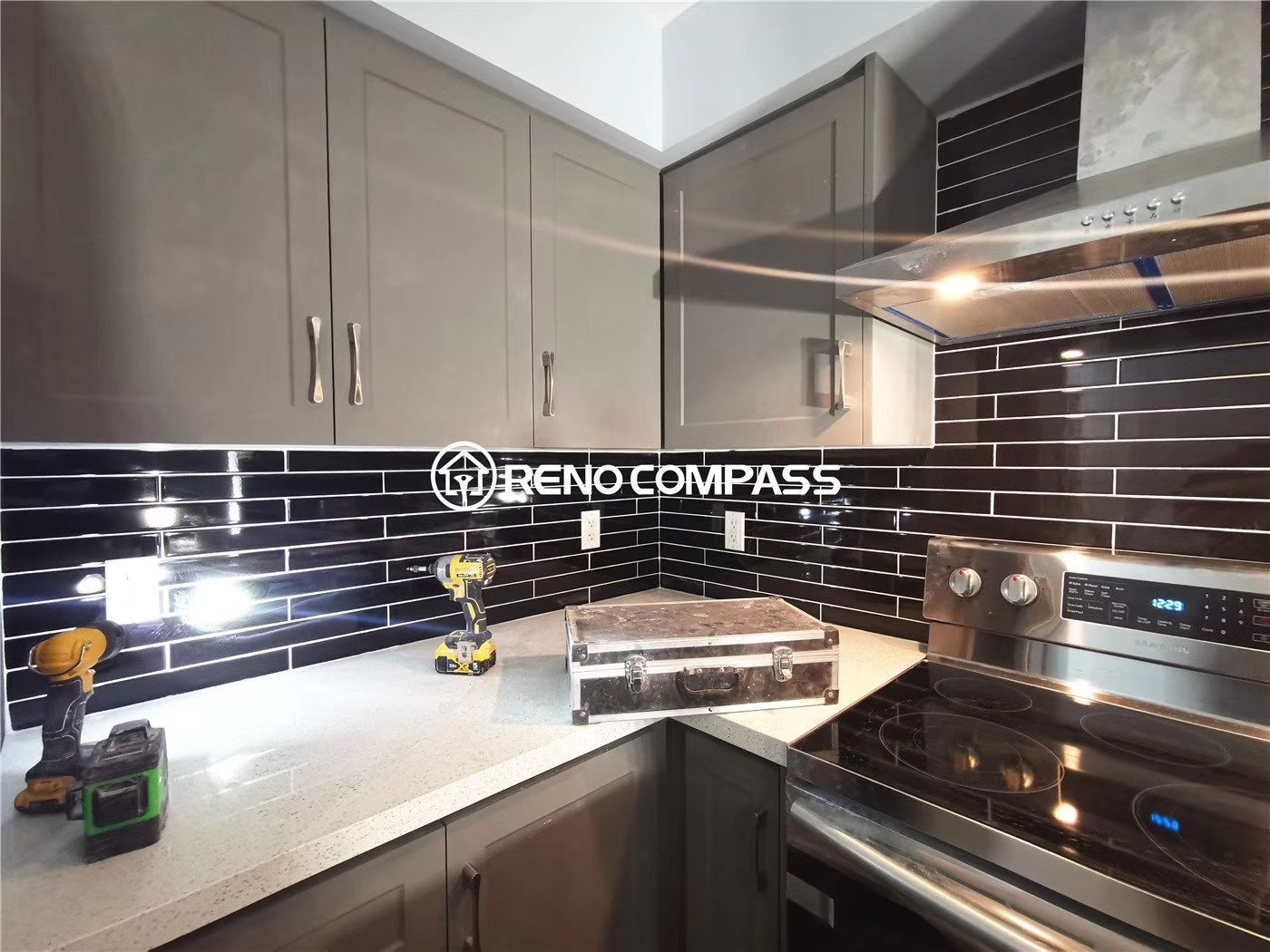 This Richmond Hill condo renovation project features a modern kitchen upgrade with newly installed cabinetry, sleek black tile backsplash, upgraded range hood, and contemporary countertop finishes. The space was redesigned to improve functionality, storage, and visual appeal within a compact condominium layout. Completed by Reno Compass, a professional Toronto renovation company, this project showcases clean design, precise installation, and practical urban living solutions for condo owners seeking a stylish and efficient kitchen transformation.