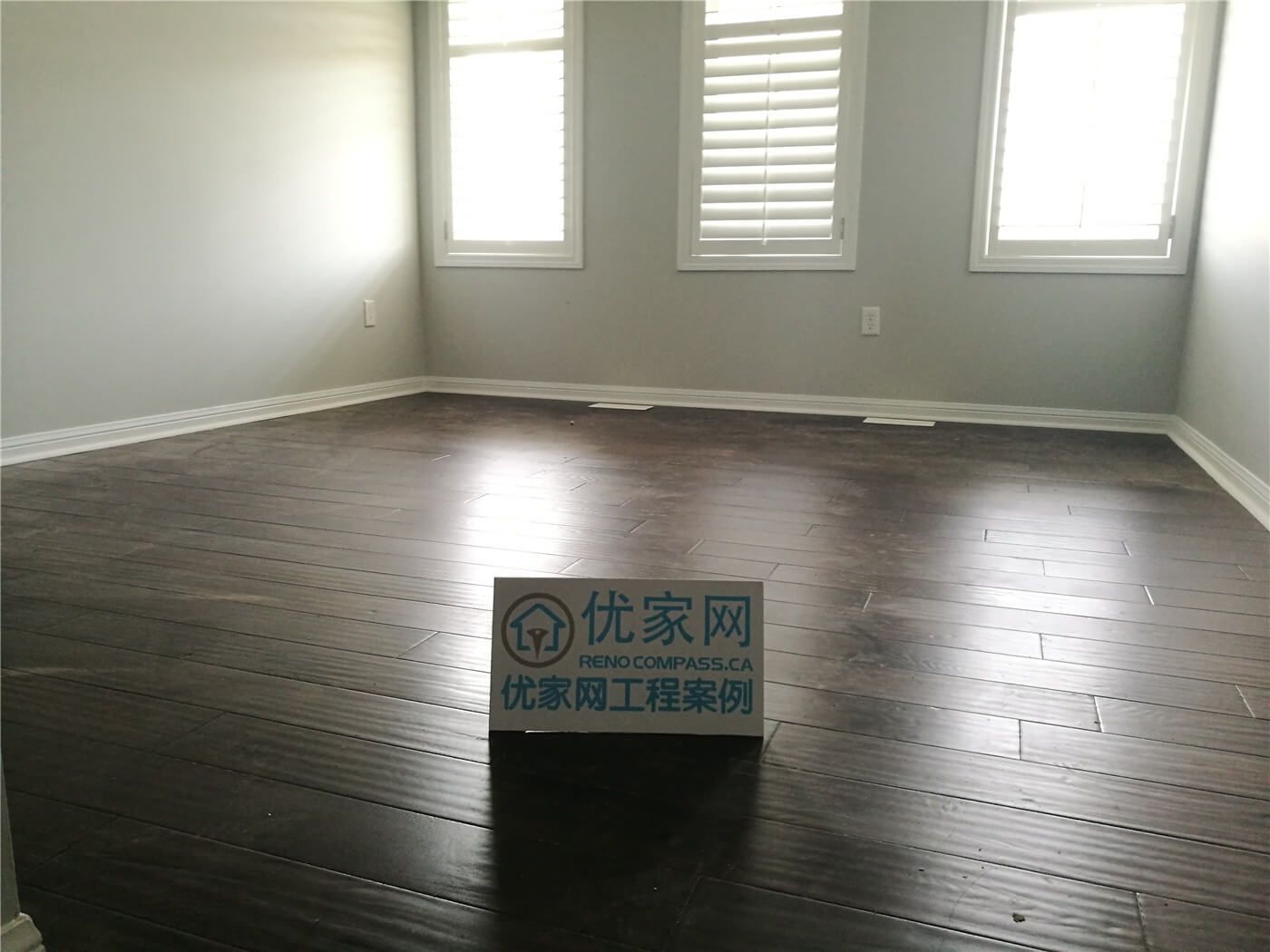 This Scarborough flooring replacement project features newly installed dark hardwood flooring that enhances the room’s depth and modern appeal. The rich wood tone contrasts beautifully with the light grey walls and white baseboards, creating a clean and contemporary atmosphere. Installed by a professional Toronto Renovation Company, the flooring was precisely aligned for a seamless finish and long-term durability.