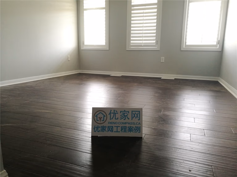 This Scarborough flooring replacement project features newly installed dark hardwood flooring that enhances the room’s depth and modern appeal. The rich wood tone contrasts beautifully with the light grey walls and white baseboards, creating a clean and contemporary atmosphere. Installed by a professional Toronto Renovation Company, the flooring was precisely aligned for a seamless finish and long-term durability.