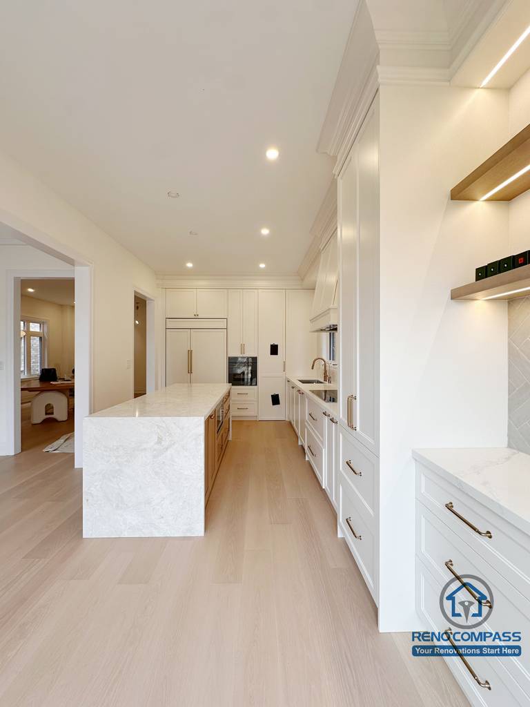 Modern kitchen layout in a Toronto new home upgrade, featuring a central island, clean walkway flow, and integrated cabinetry for improved functionality and space efficiency.