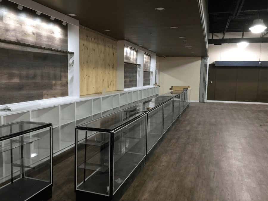 This outdoor retail store renovation features custom wall-mounted display panels, built-in shelving units, and modern glass showcase counters designed to highlight merchandise effectively. The upgraded vinyl flooring, clean ceiling finish, and strategic lighting layout create a professional and inviting shopping environment. Reno Compass Inc. delivered a functional commercial renovation that enhances product visibility, customer flow, and long-term durability for retail operations.