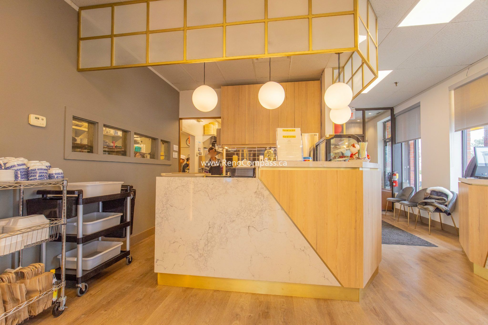 This Richmond Hill Chinese restaurant renovation by Toronto renovation company Reno Compass Inc. features a modern custom-built service counter designed to enhance workflow and customer interaction. The upgraded interior includes warm wood finishes, stone countertop detailing, modern pendant lighting, and an optimized service layout for efficient daily operation. Combining functionality with contemporary aesthetics, the renovation creates a welcoming and professional restaurant environment that elevates both brand image and overall dining experience.