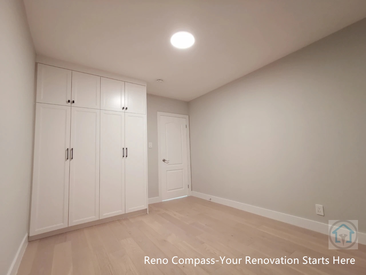 This bedroom renovation in Newmarket features custom-built white wardrobes with full-height storage, clean modern lines, and integrated hardware. Light-toned hardwood flooring, neutral wall colors, and recessed ceiling lighting create a bright and functional living space. Designed and completed by a Toronto renovation company, this project focuses on maximizing storage while maintaining a clean, minimal aesthetic suitable for everyday living.