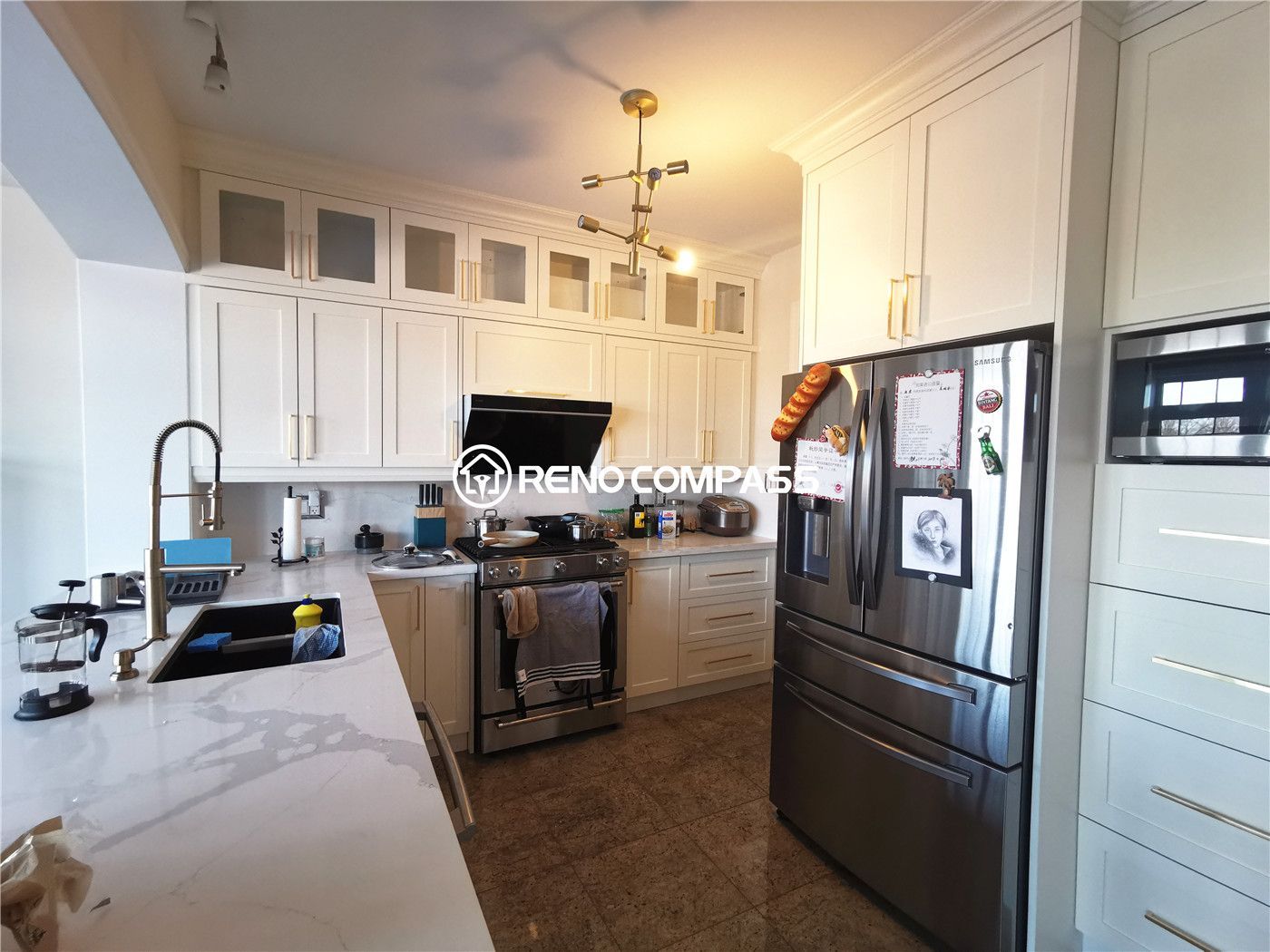 This King City kitchen renovation features custom-built white cabinetry, elegant quartz countertops, and a functional modern layout designed for everyday family living. The space was upgraded with full-height cabinets for maximum storage, a contemporary lighting fixture, and high-end stainless steel appliances to create a bright, refined, and highly practical kitchen environment. Designed and built by Reno Compass Inc., this kitchen transformation blends timeless design with modern functionality for a comfortable and stylish home upgrade.