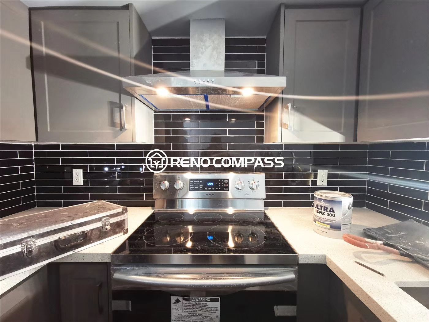 This Richmond Hill condo renovation project features a modern kitchen upgrade with newly installed cabinetry, sleek black tile backsplash, upgraded range hood, and contemporary countertop finishes. The space was redesigned to improve functionality, storage, and visual appeal within a compact condominium layout. Completed by Reno Compass, a professional Toronto renovation company, this project showcases clean design, precise installation, and practical urban living solutions for condo owners seeking a stylish and efficient kitchen transformation.
