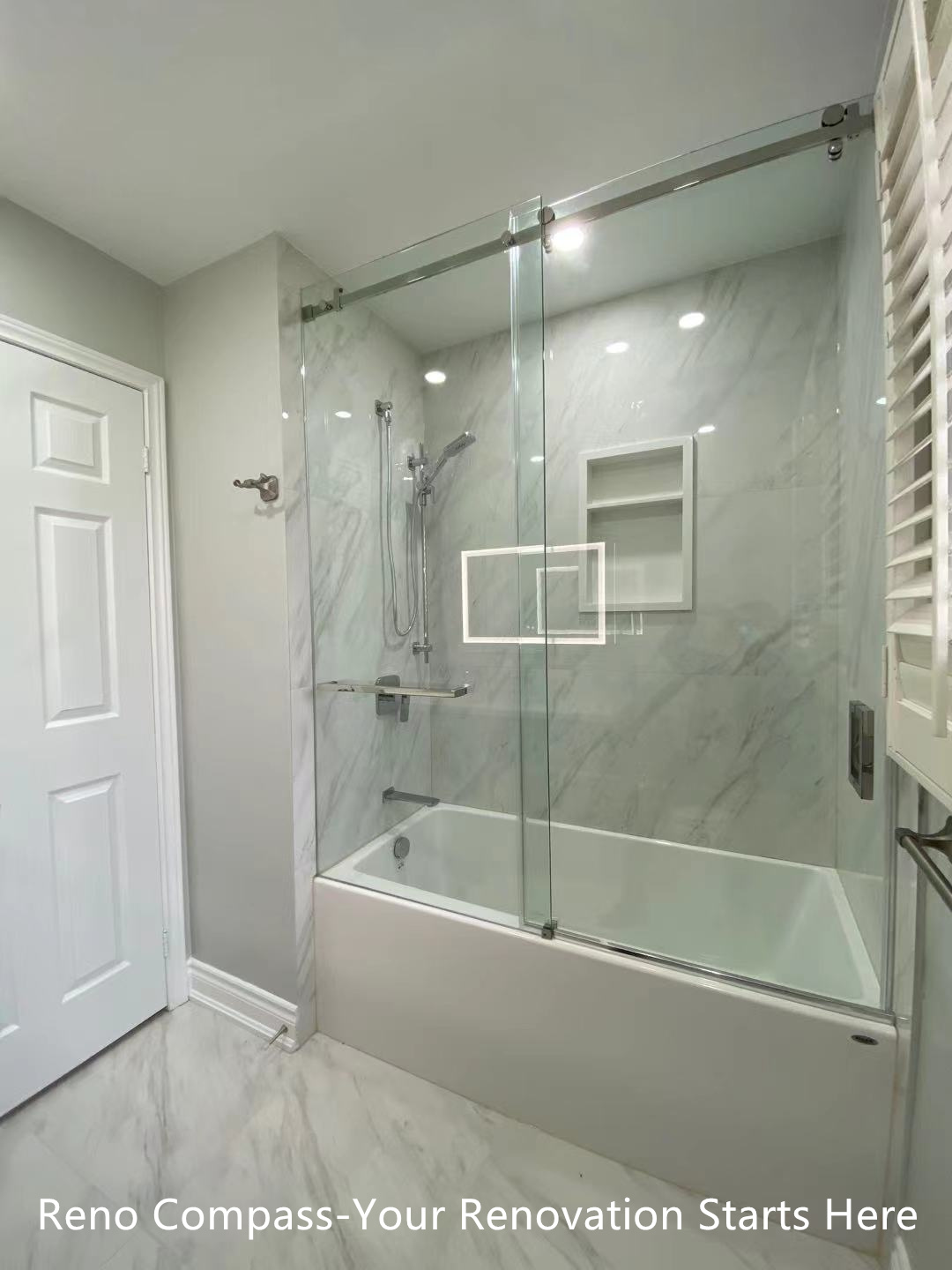 This Oakville interior renovation features a modern walk-in shower designed with frameless glass panels and full-height marble-look porcelain tiles. The clean glass enclosure enhances visual openness while allowing natural and artificial light to flow through the space. A rain shower system, wall-mounted hand shower, and built-in niche provide both comfort and functionality. The minimalist layout and neutral stone tones create a calm, spa-inspired bathroom environment that is durable, easy to maintain, and ideal for long-term residential use. This project reflects the precision detailing and modern design standards expected from a professional Toronto renovation company.