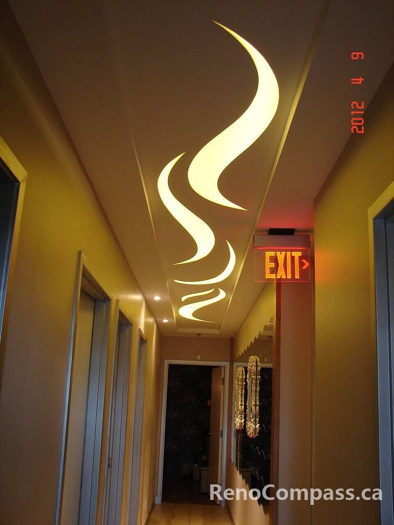 This Toronto beauty salon commercial renovation showcases a striking custom LED ceiling design that creates a luxurious and modern hallway experience. The flowing light feature enhances spatial depth while guiding clients through the space with a warm, welcoming ambiance. Designed for both visual impact and functionality, this commercial interior renovation highlights premium craftsmanship and contemporary salon aesthetics by a professional Toronto renovation company.