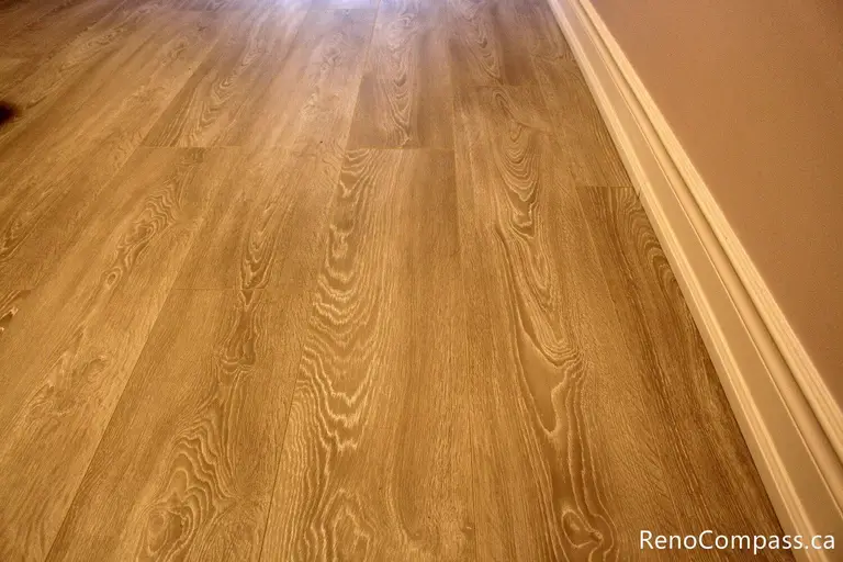 A close-up showcase of professional baseboard installation and seamless flooring transitions in an Oshawa home. Reno Compass ensures high-quality craftsmanship in every corner, providing clean lines for a polished interior renovation.