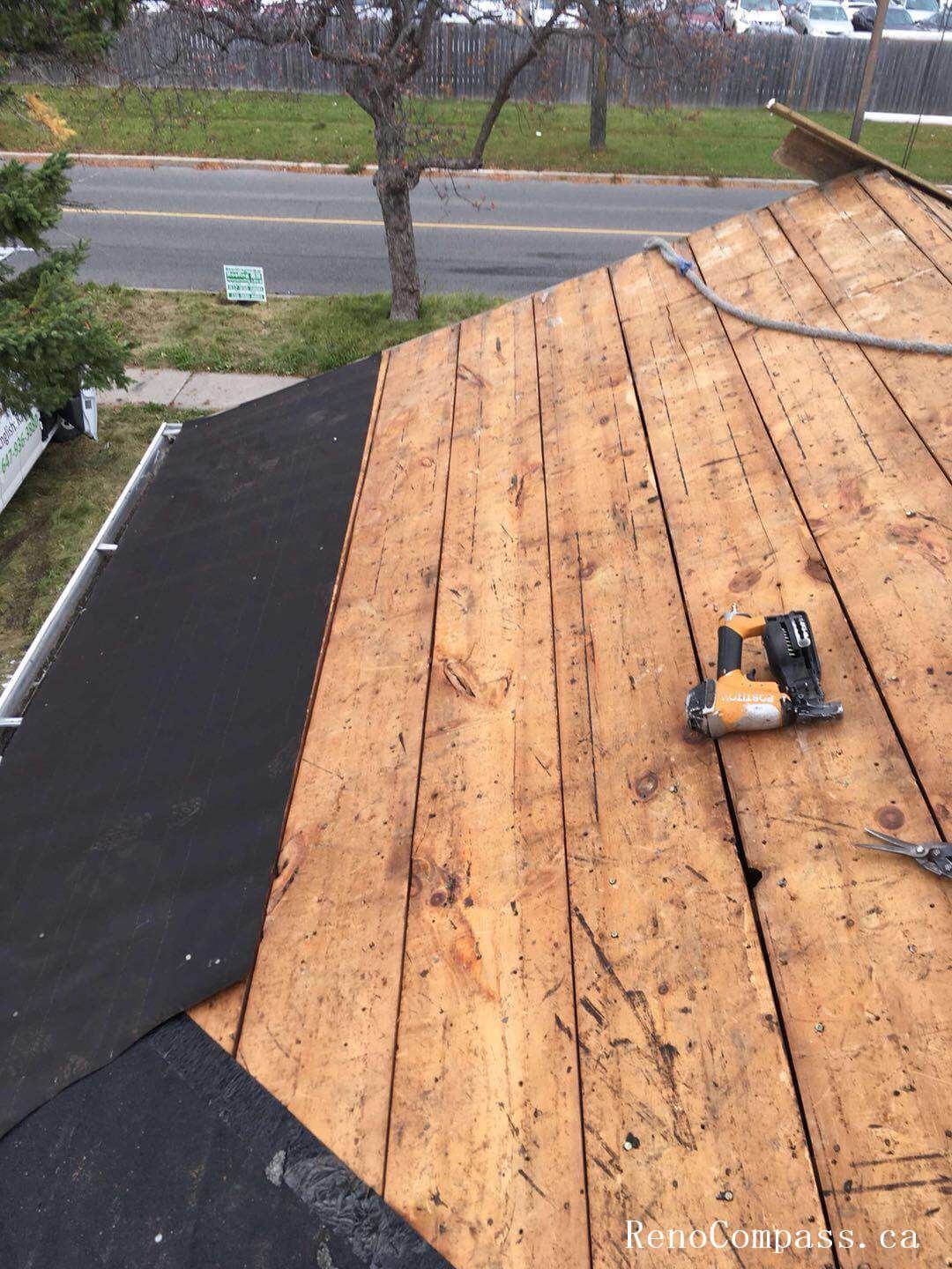 This image captures the mid-stage of a roofing replacement project in Toronto, showing newly installed roof decking and waterproof underlayment preparation. The old roofing materials have been removed to expose the wooden roof structure, allowing the team to reinforce the base and ensure proper alignment before installing new shingles. High-quality waterproof membrane layers are applied to enhance moisture protection and improve long-term durability against Toronto’s harsh weather conditions. This professional roofing replacement process ensures structural integrity, proper insulation support, and a reliable foundation for the final roofing system installation on residential properties.