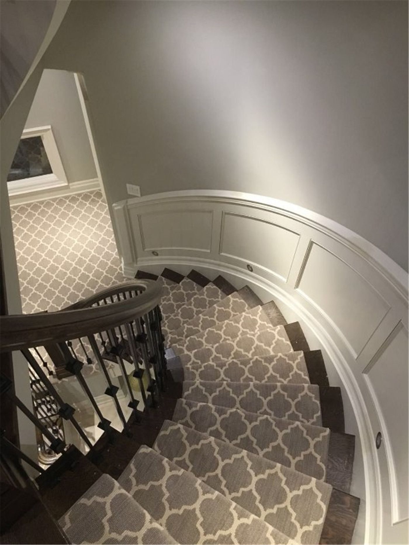 This Toronto interior renovation project features a custom curved staircase carpet installation designed to enhance both safety and visual elegance. The patterned stair runner was carefully measured and fitted along the curved staircase to ensure seamless alignment and long-term durability. Paired with dark wood stair treads, classic wall paneling, and neutral wall tones, the carpet adds warmth, comfort, and a refined finish to the home’s interior.

Installed by an experienced Toronto renovation company, this project highlights precise workmanship, detailed stair fitting, and high-quality materials, creating a timeless and functional staircase upgrade suitable for modern residential interiors.