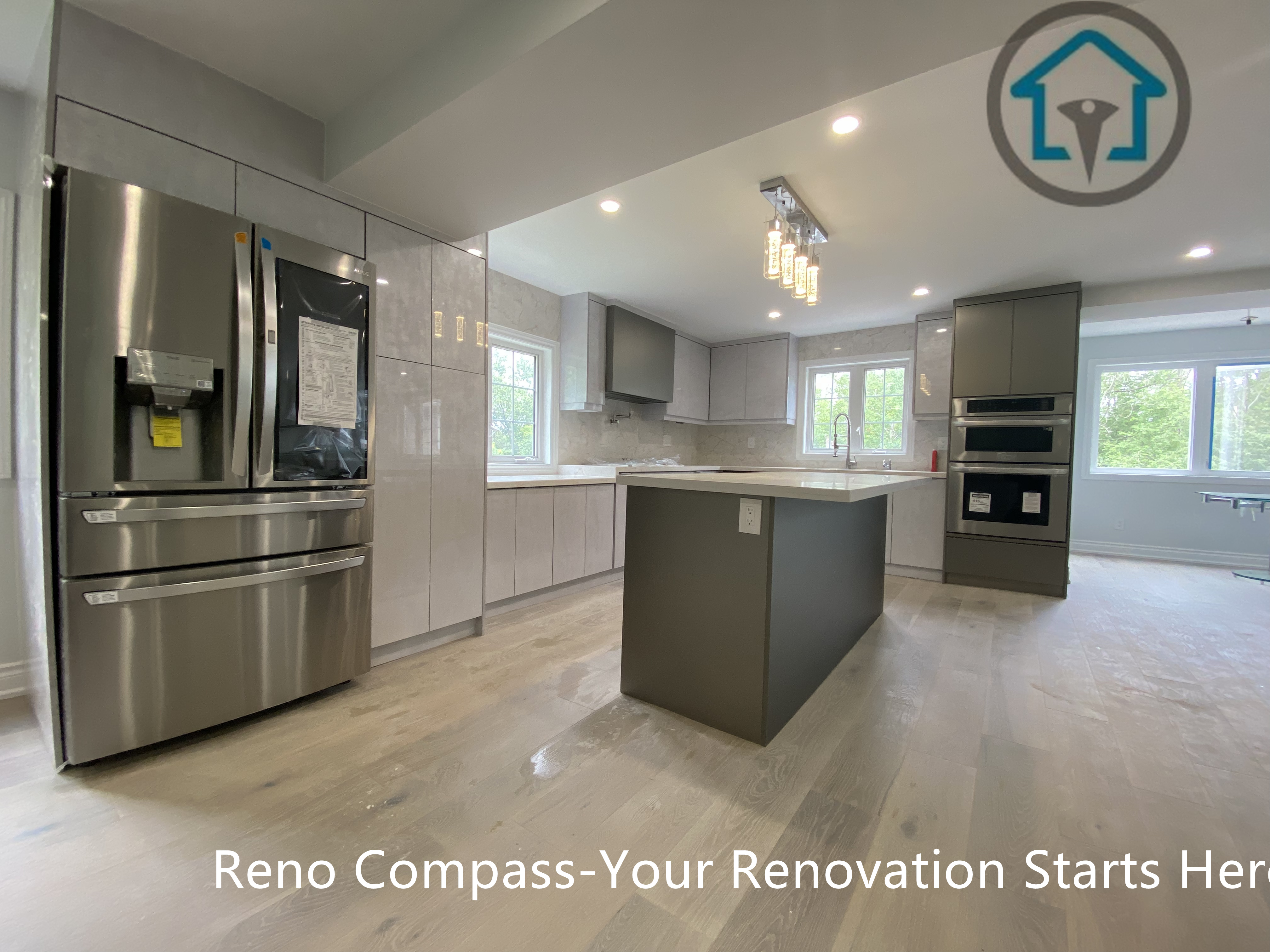 This modern kitchen renovation in Stouffville features a spacious central island, full-height cabinetry, and integrated appliances. The clean grey palette, quartz countertops, and recessed lighting create a bright, functional space designed for everyday cooking and entertaining.