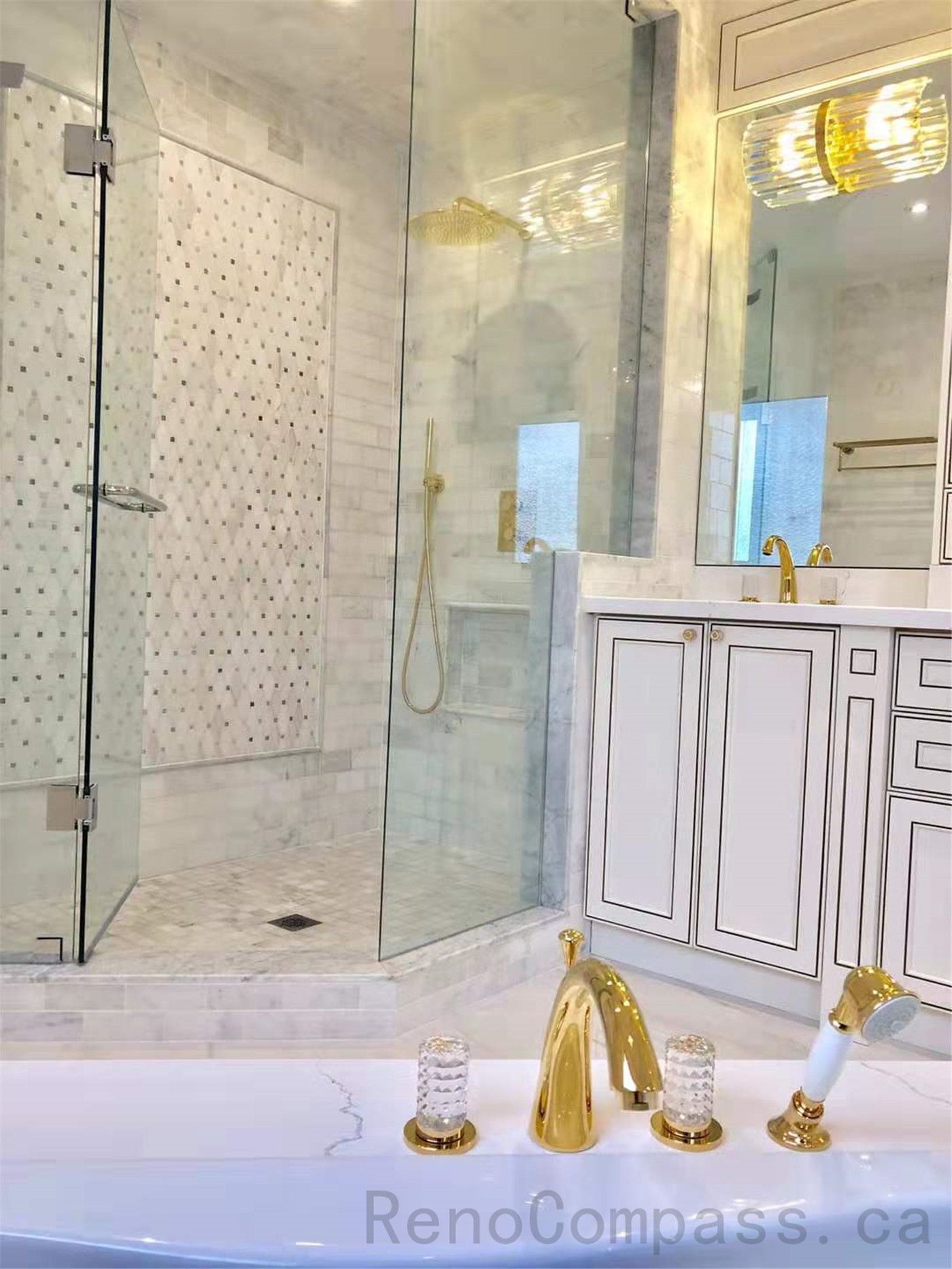 This North York bathroom renovation features a modern glass walk-in shower with marble-look wall tiles and mosaic accent details, paired with a custom vanity, quartz countertop, and elegant gold fixtures. The bright and refined layout enhances both functionality and luxury, creating a timeless and comfortable bathroom space. Completed by a professional Toronto renovation company specializing in high-end residential renovations.