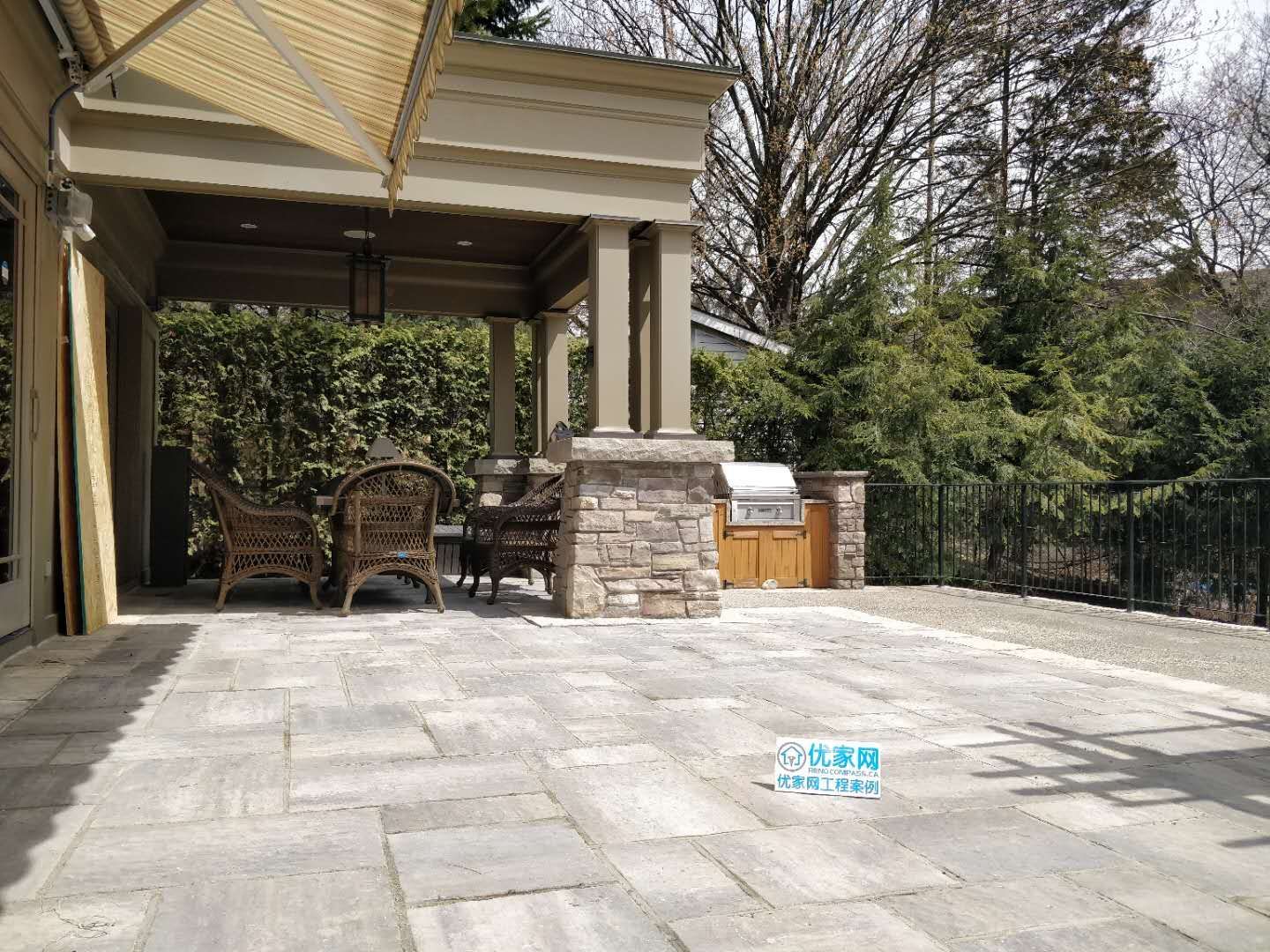 Professional Oakville landscaping project featuring natural stone retaining walls, a custom wooden pergola, and a well-integrated sloped lawn design. Built for durability, drainage, and elegant outdoor living space enhancement.
