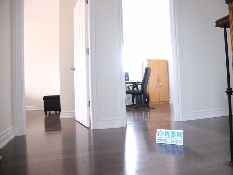 Interior view of a Scarborough home addition project featuring newly installed hardwood flooring, bright hallway space, and upgraded room layout. The renovation improves interior flow, lighting, and modern living comfort as part of a complete home expansion project.