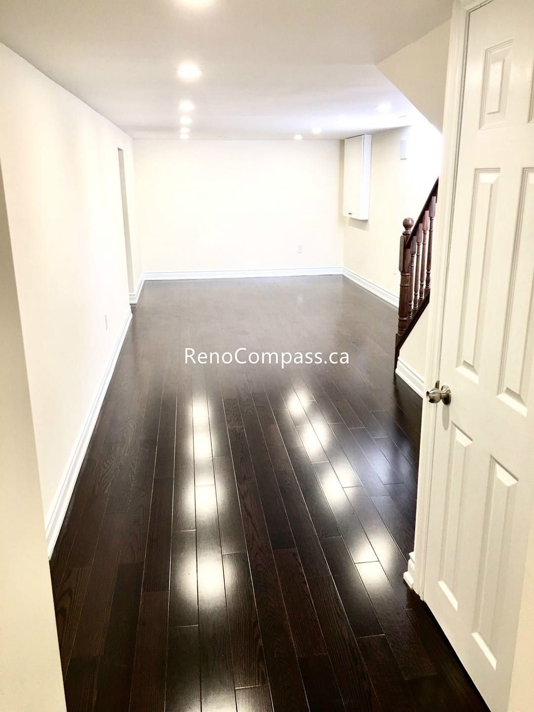 This Toronto basement renovation features newly installed hardwood stairs and matching engineered flooring, creating a clean and modern transition between levels. The upgraded staircase railing and rich wood tones enhance durability, safety, and overall home value. Completed by a professional Toronto renovation company, this project highlights quality craftsmanship and functional design for contemporary basement living spaces.