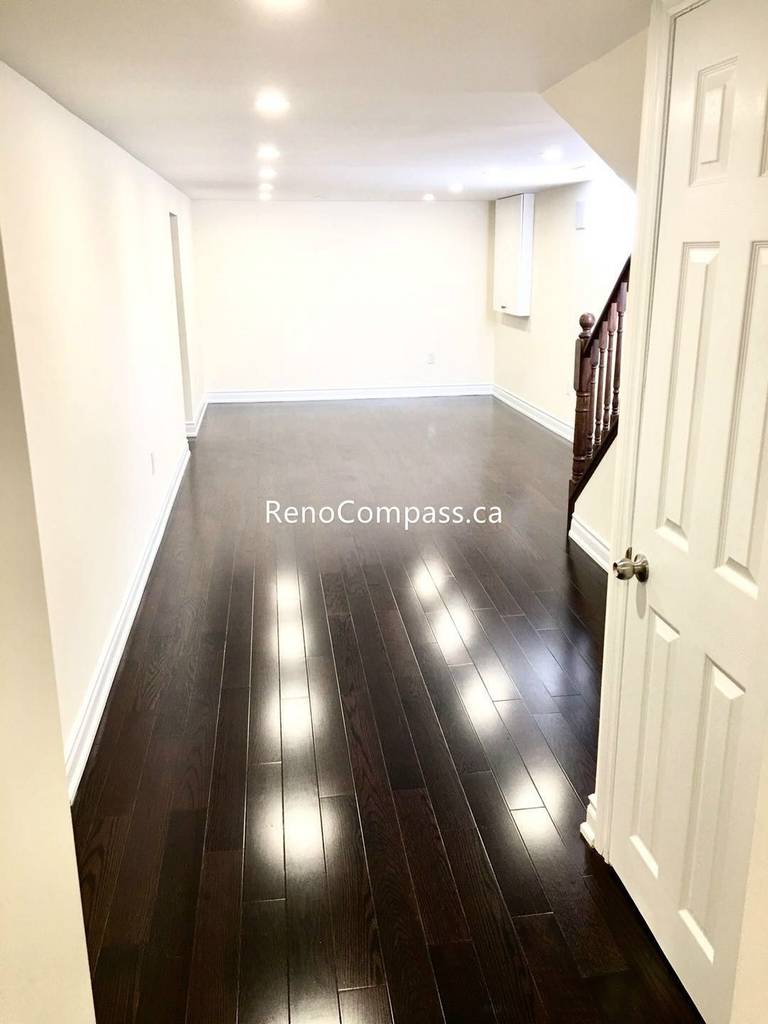 This Toronto basement renovation features newly installed hardwood stairs and matching engineered flooring, creating a clean and modern transition between levels. The upgraded staircase railing and rich wood tones enhance durability, safety, and overall home value. Completed by a professional Toronto renovation company, this project highlights quality craftsmanship and functional design for contemporary basement living spaces.