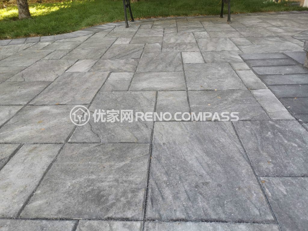 Modern interlocking stone surface with clean lines and neutral tones, adding durability and style to a Richmond Hill backyard.